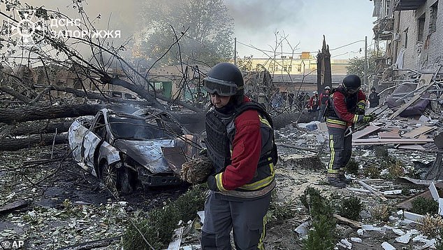 Ukrainian Emergency Service workers clear debris after Russia attacked the city with guided bombs overnight in Zaporizhzhia, Ukraine, Sunday, September 29.