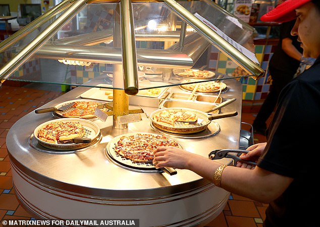 Freshly baked pizzas are displayed at the air-conditioned buffet station.