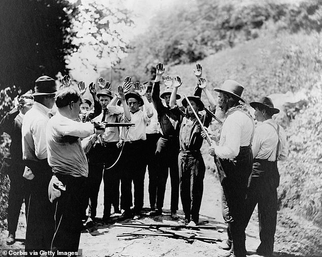 Shown above is a group of Hatfield gunmen in the late 19th century stopping men, possibly McCoys, on the side of the road.