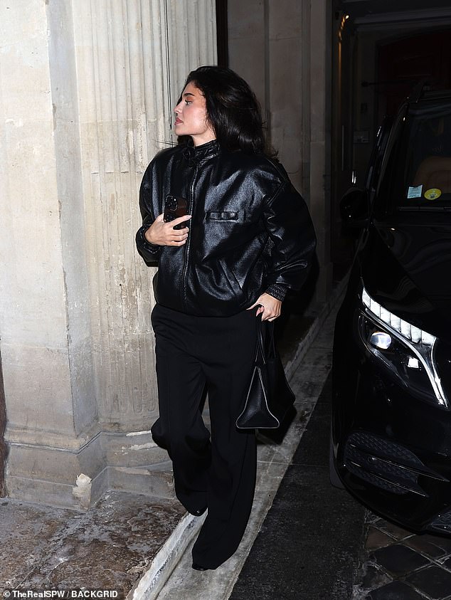 The Kylie Cosmetics mogul, 27, wore a black leather bomber jacket by designer Phoebe Philo over a black turtleneck and black pants.