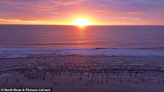 Men and women, of different ages, enjoyed their morning jumping into the icy water at dawn in calm conditions.