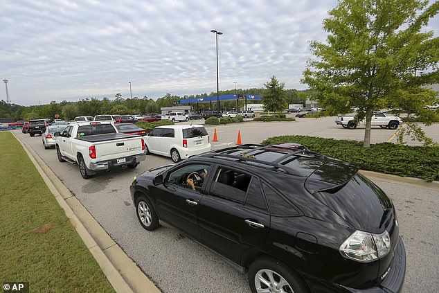 Residents line up to buy gas at Sam's Club after Hurricane Helene on Sunday.