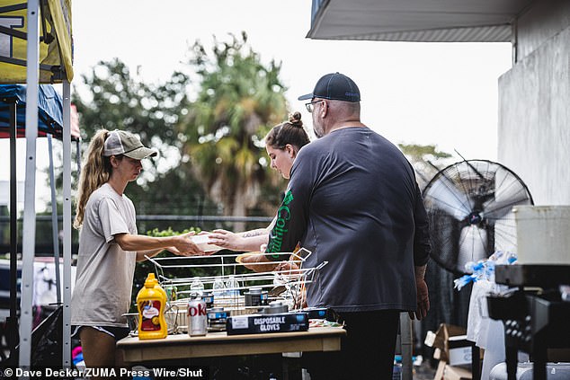 Residents feed people at the mutual aid site hosted by Shady Hills Little League in the City of Hudson.