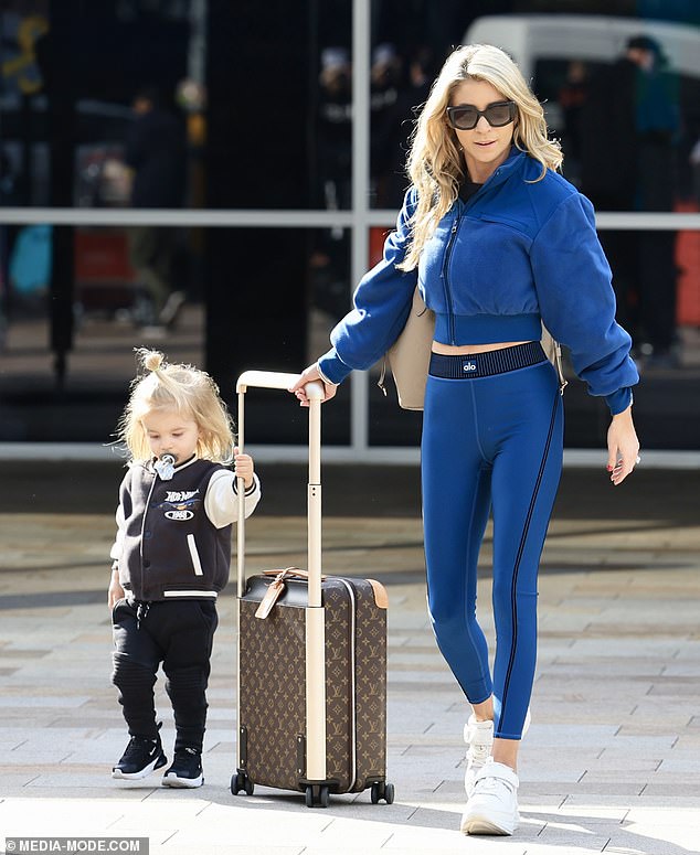 The little boy looked adorable in a black and white bomber jacket with jeans and matching sneakers alongside his glamorous mother.