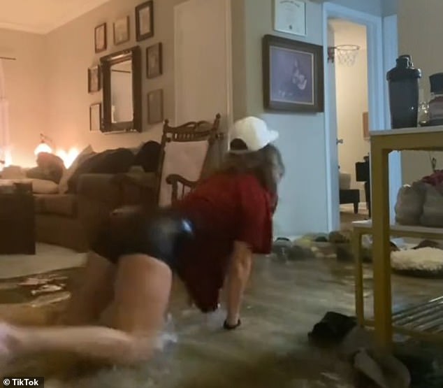 In a 15-second video posted online, which has been viewed more than 13 million times, the woman could be seen sliding across the hardwood floor toward her family's living room.