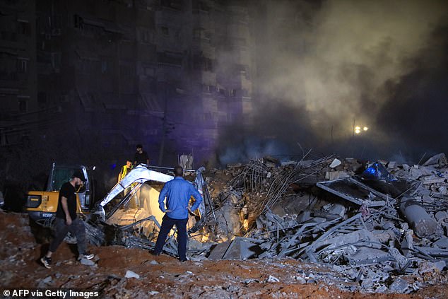 First responders and civilians used a spread to clear debris after the airstrike in Haret Hreik, south of Beirut, on September 27.