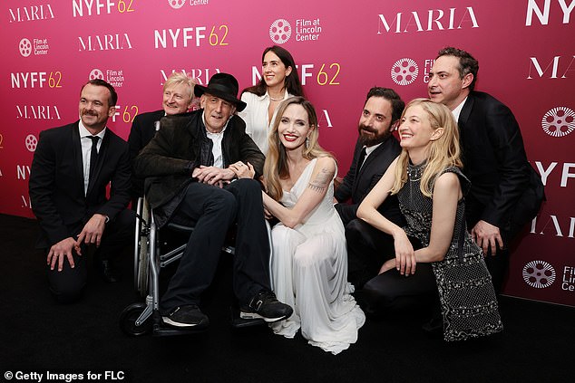 Jolie happily posed with the cast and crew.