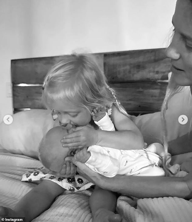 Pfeiffer gave her little brother a kiss in another black and white photo