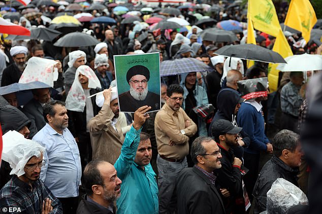 A protester holds a photograph of late Hezbollah leader Hassan Nasrallah during an anti-Israel protest in Palestine Square in Tehran, Iran, on September 28, 2024.