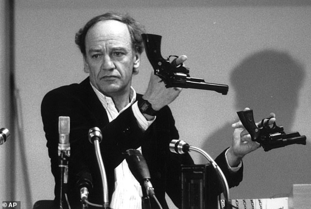 Hans Holmer, former head of the investigation into the assassination of Swedish Prime Minister Olof Palme, displays two Smith & Wesson .357 Magnum revolvers during a news conference in Stockholm.