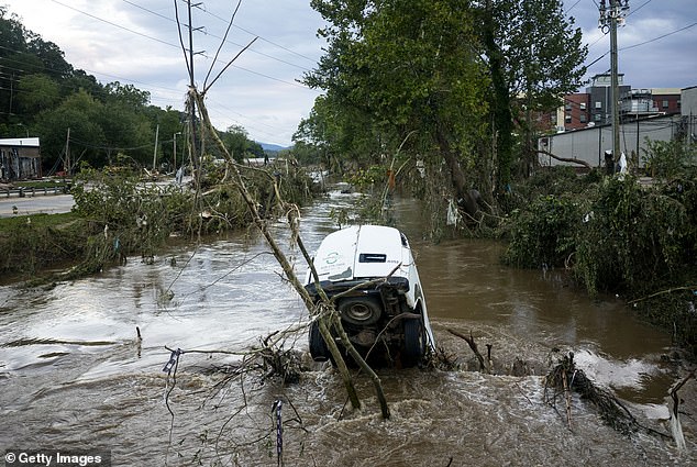 The once picturesque town is now in ruins. Cars are perched on tree branches along the flooded Swannanoa River