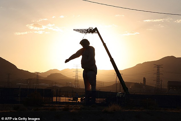 The statue is seen getting some sun where the sun doesn't shine in the Nevada desert on Saturday.