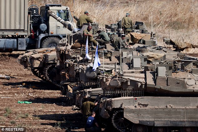 Israeli armored military vehicles stand in formation, amid cross-border hostilities between Hezbollah and Israel, in northern Israel, September 30, 2024, amid reports of an invasion 