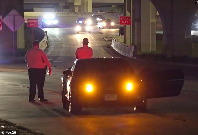 However, it is believed that the car may have been rolling for some time before coming to a complete stop. Here you see the police officers gathered around the 2013 muscle car.