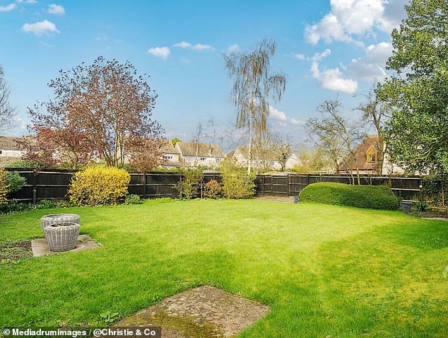 The outdoor area features plenty of green space along with a covered area at the back.