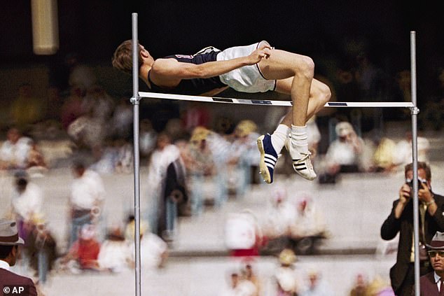 Dick Fosbury of the United States breaks the barrier in the high jump competition at the 1968 Mexico City Olympics