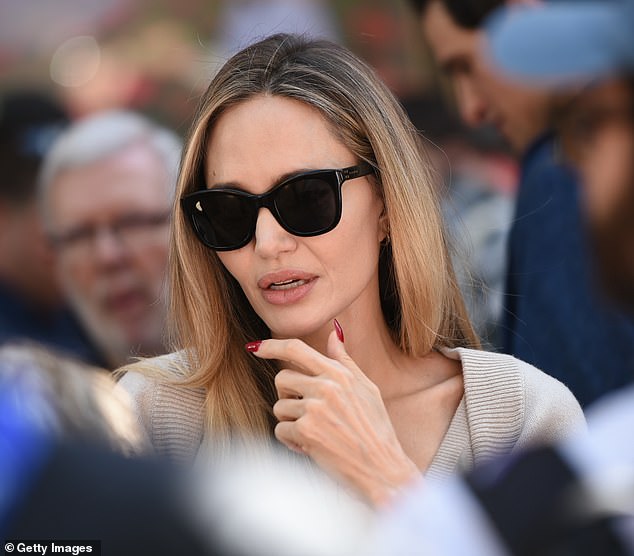 The Tomb Raider star wowed in a flowing grey dress with long sleeves at the event, after returning from Italy where she attended the Venice Film Festival.