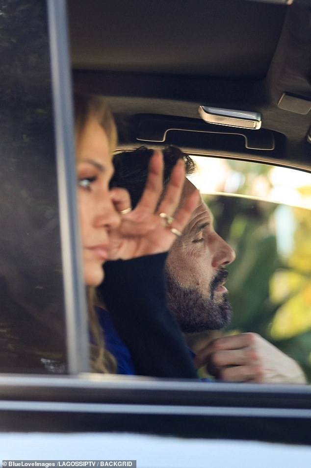 Later, as they sat in their car, Jennifer appeared to wipe away tears.