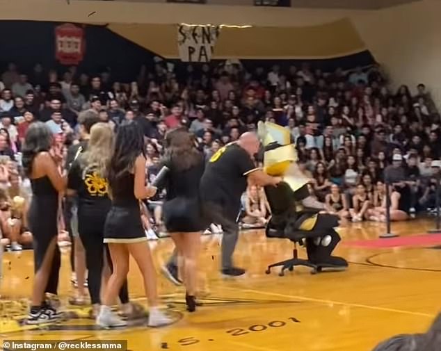 Nunes can be seen pushing the mascot out of the school gymnasium.