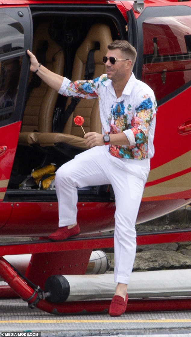 Jumping out of a bright red helicopter, the batsman could be seen enjoying a large lollipop in character while dressed in a stylish white ensemble.