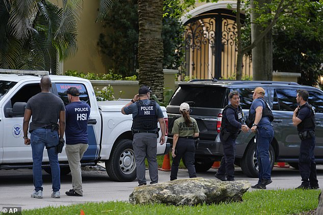 Police and agents are seen surrounding Diddy's Miami home in March after conducting raids.