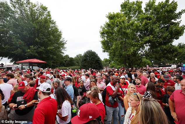 Fans wait outside Bryant-Denny Stadium as security tightens before the game.