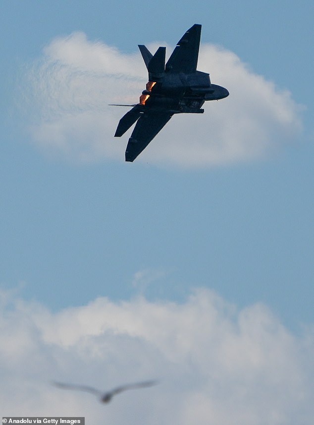 The bizarre image shows a seemingly circular white object that had been shot down by a US Air Force F-22 Raptor stealth fighter on a joint mission with the Canadian Armed Forces. Above, another USAF F-22 Raptor during an air show over Toronto, Canada, on August 31, 2024.