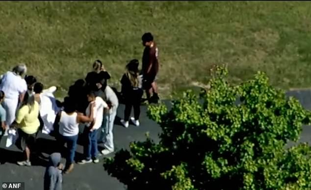 Live footage showed a student bent over under a blanket alongside nearby ambulances.