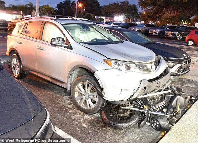 Police say it was Tate's SUV with the motorcycle tangled underneath. She abandoned her car outside a Hyundai dealership and was picked up in a sedan, according to court documents.