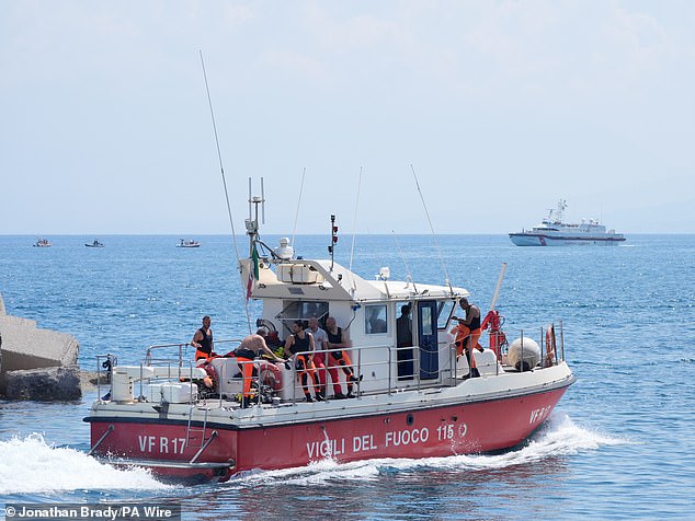 A fire service diving team leaves Porticello, heading for a rescue site in Sicily, August 23.