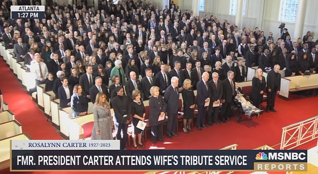 First ladies sitting in the front row at Rosalynn Carter's service, Melania Trump is seated next to Michelle Obama and across from Kamala Harris.