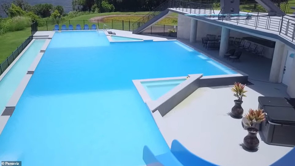 The Olympic swimming pool extends the length of the mansion.