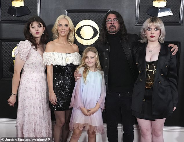 Grohl and his wife Jordyn share three daughters: Violet, Harper and Ophelia (pictured at the 2023 Grammy Awards)