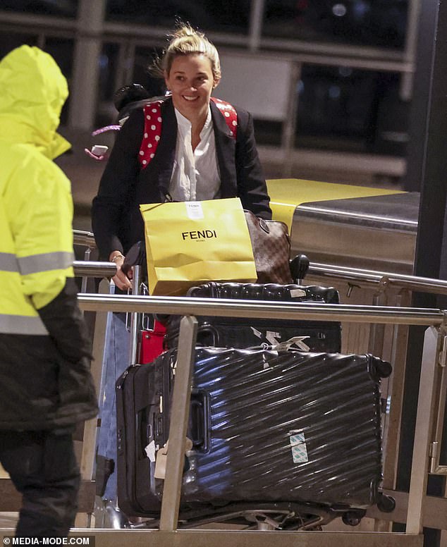 Jasmine appeared to have purchased some luxury items at the airport as she carried a bright yellow Fendi shopping bag along with her luggage.