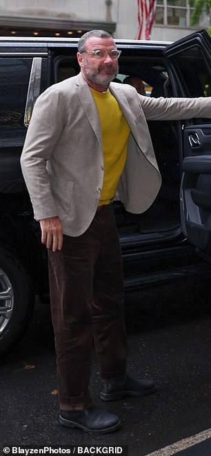 He looked charming in a knitted jacket and yellow sweater paired with brown pants as he stepped out of his car.