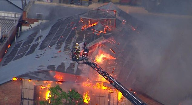 Man fights for life as massive building fire blankets Brisbane