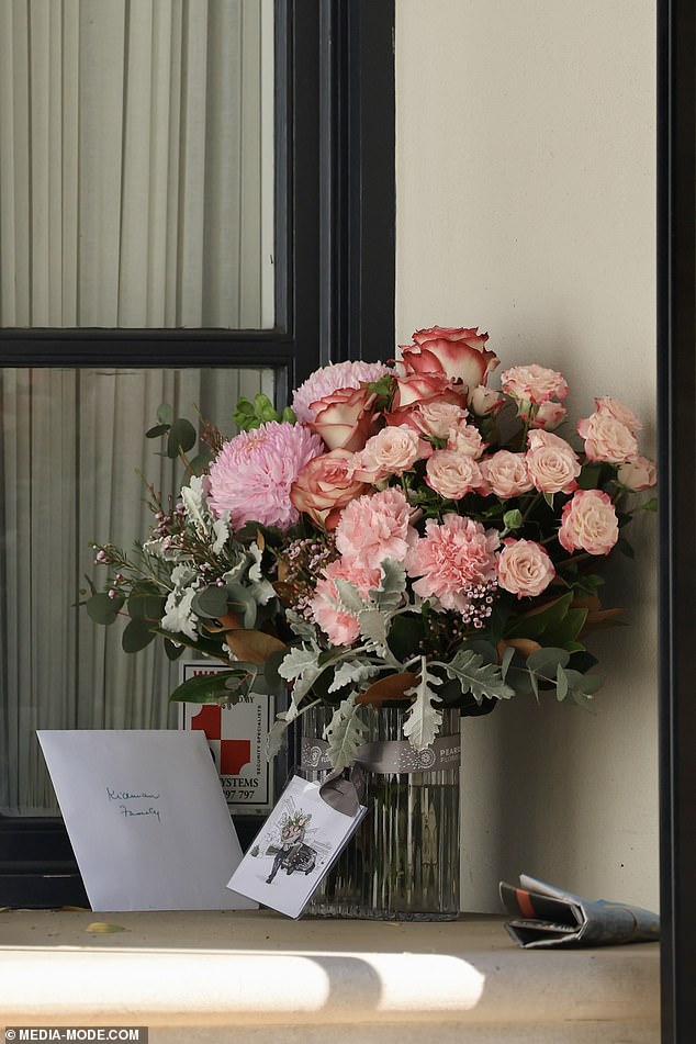 A vase of pink flowers was left abandoned at the door along with a heartfelt letter.