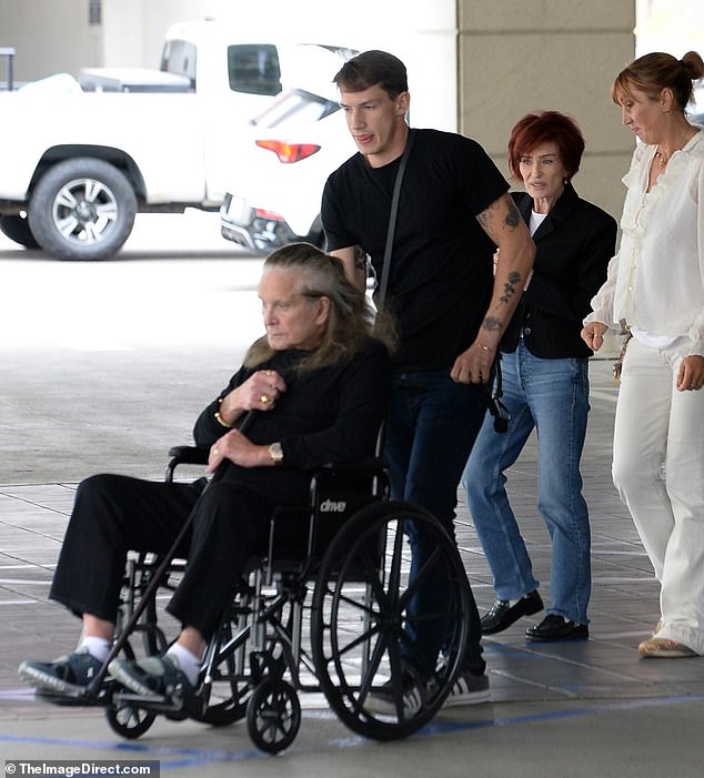 The 75-year-old rocker was pushed in a wheelchair before getting up and using a cane to walk.