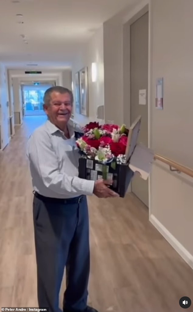 In the clip, Savvas is visiting his wife in her nursing home in Australia and is carrying a huge bouquet of flowers.