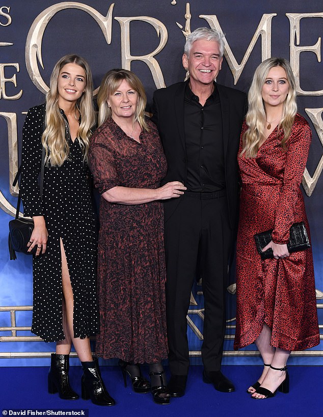 Phillip recalled how a conversation with his daughters Molly, 31, and Ruby, 28, prevented him from moving forward (pictured with wife Stephanie Lowe, Molly and Ruby in 2018).