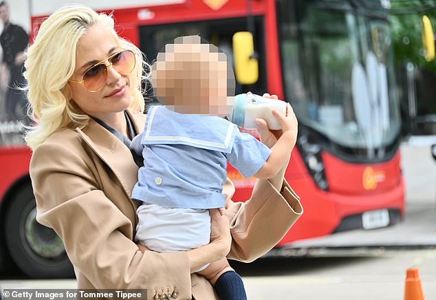 However, the singer appears to have left clubbing behind and is now a working mum, as she was pictured today breastfeeding her 10-month-old son while travelling between shows at London Fashion Week (pictured).