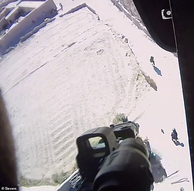 A warning shot is shown about to be fired from a military helicopter in Afghanistan.