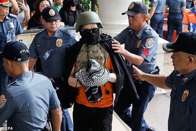 Filipino televangelist Apollo Quiboloy (C) arrives at a court for his scheduled appearance in Pasig City, Metro Manila, Philippines