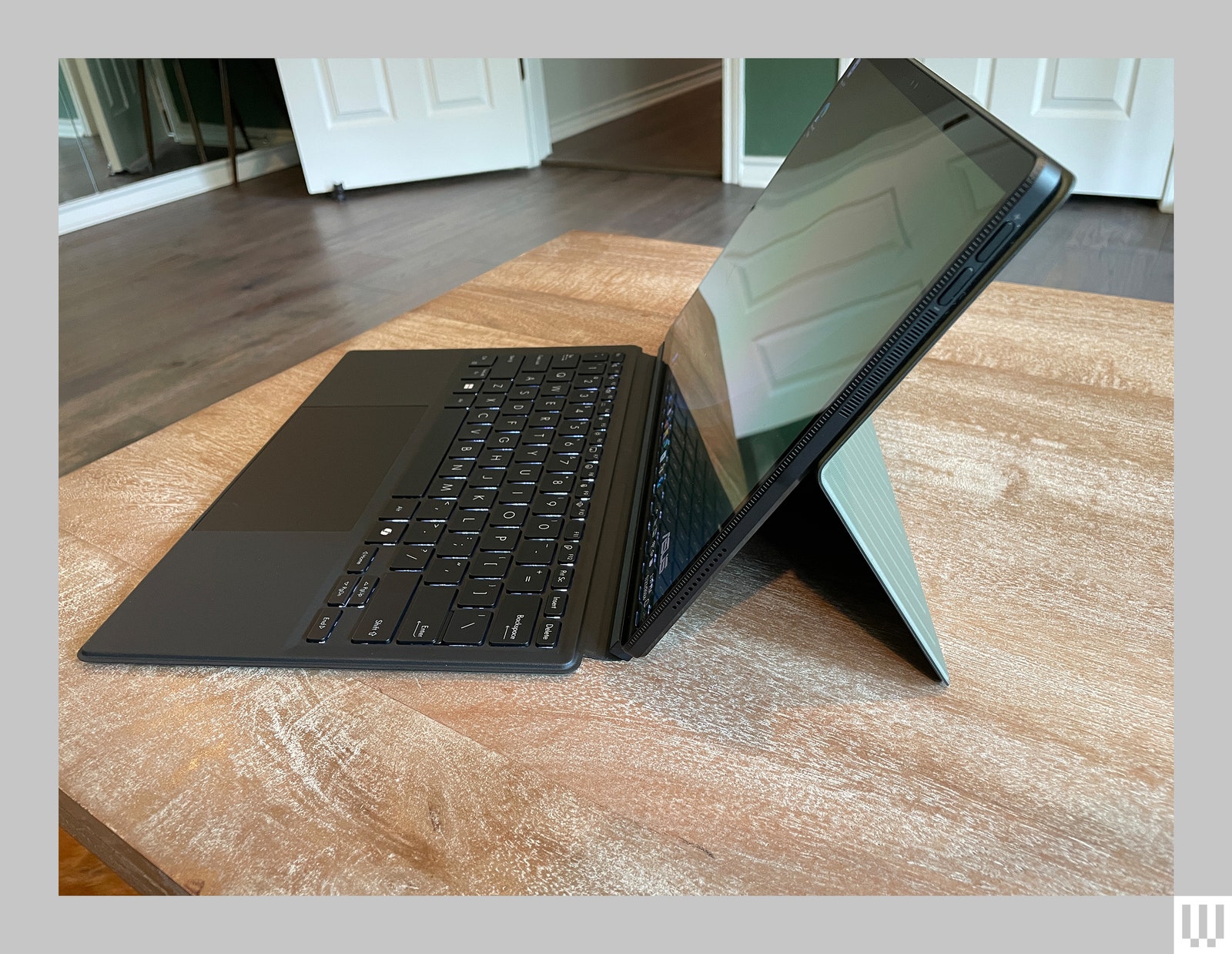 Side view of a laptop composed of a detachable tablet keyboard and a case with a stand