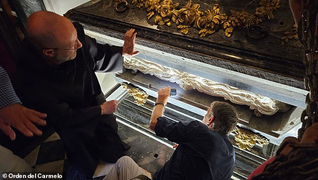 The remains of St Teresa were moved to a closed room where experts can analyse her DNA and understand how to best preserve the relics in the future. Pictured: The marble-clad silver coffin of St Teresa of Avila