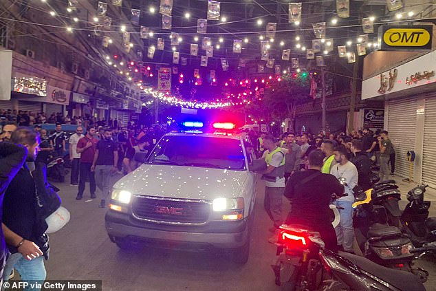 Emergency crews gather at the site of an Israeli attack in Beirut's southern suburbs