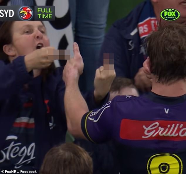 Grant gives a thumbs up to a very disgruntled Roosters fan who was making a rude gesture towards star Storm Hooker.