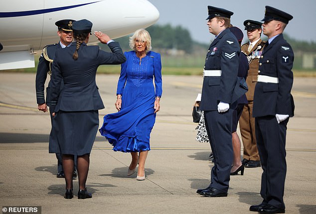 She wore an elegant blue Fiona Clare dress and commented on the wind blowing through her hair and outfit.