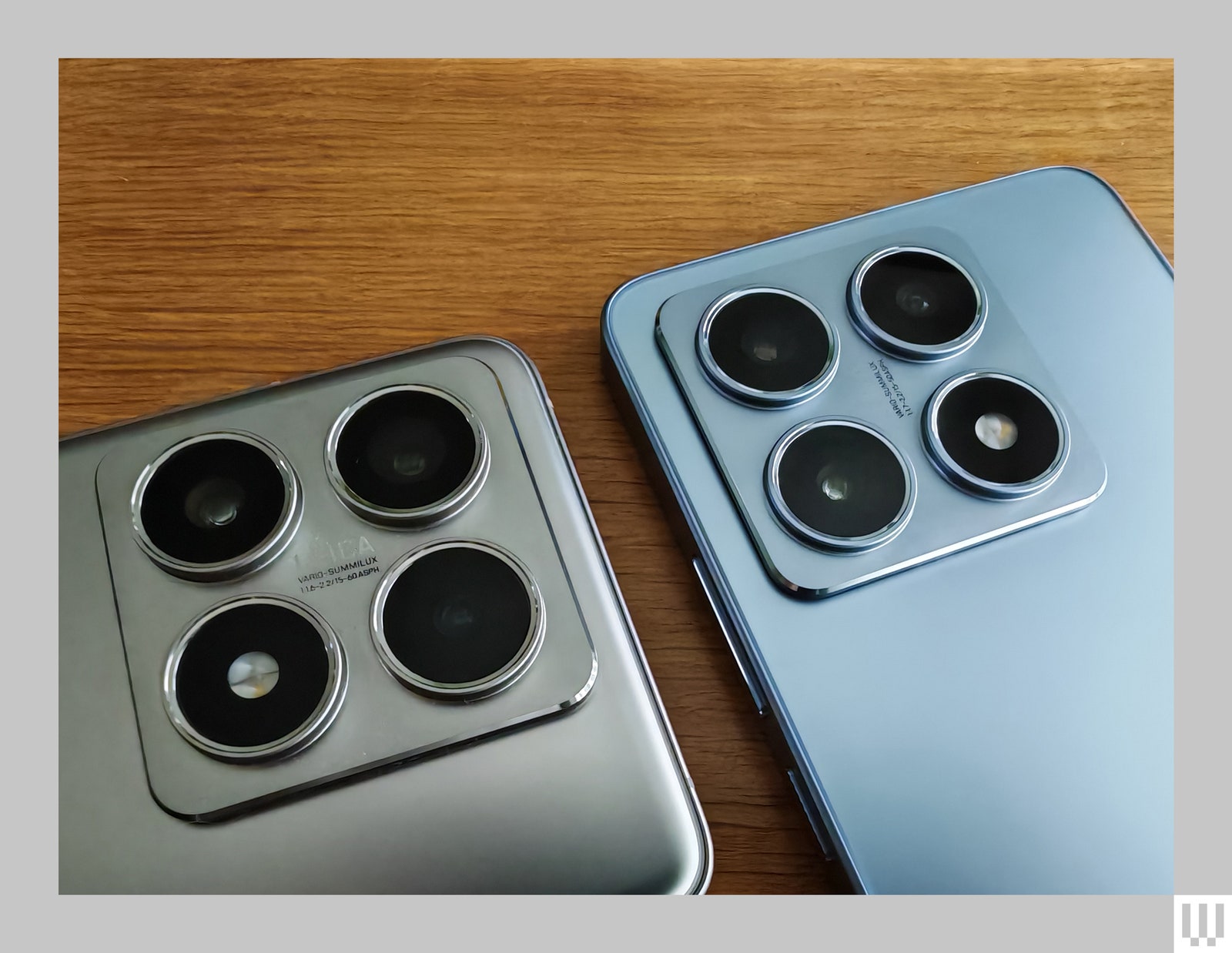 Close-up of the rear cameras of two mobile phones side by side