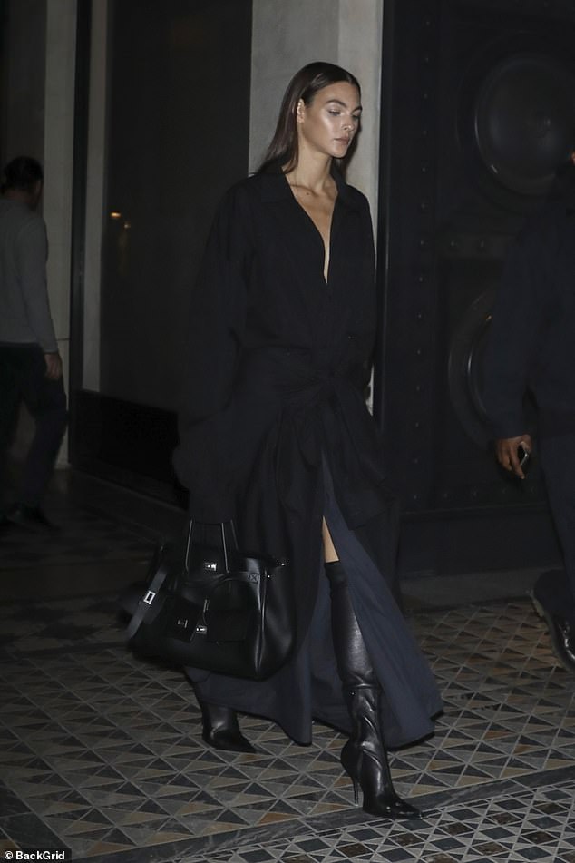 She added inches to her figure in a pair of pointed over-the-knee stiletto boots and carried her essentials in a black Hermès bag.